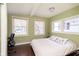 Serene bedroom with natural light, hardwood floors, and a comfortable bed with decorative pillows at 5110 Riverview Dr, Indianapolis, IN 46208