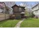 Charming two-story home with a well-manicured lawn and a walkway leading to the front entrance at 5110 Riverview Dr, Indianapolis, IN 46208