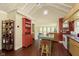 Bright kitchen featuring vaulted ceilings, an island, and hardwood floors at 5110 Riverview Dr, Indianapolis, IN 46208