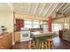 Kitchen with a vaulted ceiling, island with stools, and hardwood floors at 5110 Riverview Dr, Indianapolis, IN 46208