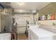 Bright laundry room with white washer and dryer and ample storage space at 5110 Riverview Dr, Indianapolis, IN 46208