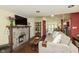 Open-concept living room showcases a rustic stone fireplace, hardwood floors, and comfortable furnishings at 5110 Riverview Dr, Indianapolis, IN 46208