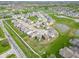 A neatly planned community offers modern homes and attractive green spaces in an aerial view at 5218 Triple Crown Way, Indianapolis, IN 46237
