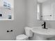 Modern half bathroom with stylish sink and fixtures and natural light at 5218 Triple Crown Way, Indianapolis, IN 46237
