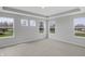 A bright bedroom with tray ceilings and three large windows offering an excellent view at 5218 Triple Crown Way, Indianapolis, IN 46237
