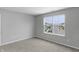 Bedroom with a street view from the window and neutral paint and carpet at 5218 Triple Crown Way, Indianapolis, IN 46237