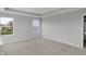 Carpeted bedroom with an exterior window and door leading to an adjoining space at 5218 Triple Crown Way, Indianapolis, IN 46237