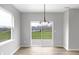 Bright dining area with sliding door access to outside and modern chandelier at 5218 Triple Crown Way, Indianapolis, IN 46237