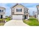 Charming two-story home featuring a two-car garage and classic architectural details at 5218 Triple Crown Way, Indianapolis, IN 46237