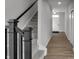 Hallway and staircase with neutral carpet and plank flooring at 5218 Triple Crown Way, Indianapolis, IN 46237