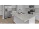 Modern kitchen island with stainless steel sink and stainless steel appliances at 5218 Triple Crown Way, Indianapolis, IN 46237
