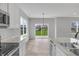 Open floor plan with kitchen and dining area with stainless steel appliances at 5218 Triple Crown Way, Indianapolis, IN 46237