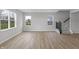 Bright living room area with stairs and large windows at 5218 Triple Crown Way, Indianapolis, IN 46237