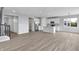 Spacious living room with hardwood floors and an adjacent open kitchen area at 5218 Triple Crown Way, Indianapolis, IN 46237