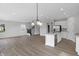 Spacious open floor plan with a kitchen, staircase, and living area at 5218 Triple Crown Way, Indianapolis, IN 46237