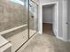 Modern bathroom featuring a tiled shower with bench, glass door, and access to walk-in closet at 5267 Chambers Ct, McCordsville, IN 46055