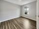Cozy bedroom with hardwood floors, neutral walls, and bright window at 5267 Chambers Ct, McCordsville, IN 46055