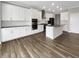 Modern kitchen featuring stainless steel appliances, granite countertops, and ample cabinet space at 5267 Chambers Ct, McCordsville, IN 46055