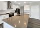 Modern kitchen with stainless steel appliances, large island, and white cabinets at 5267 Chambers Ct, McCordsville, IN 46055
