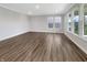 Bright living room with hardwood floors, large windows, and neutral walls at 5267 Chambers Ct, McCordsville, IN 46055