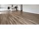 Open concept living space with hardwood floors connecting the kitchen and living room at 5267 Chambers Ct, McCordsville, IN 46055