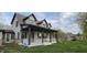 Inviting two-story home featuring a cozy front porch with swing and a lush green lawn at 543 Schooley Dr, Greenwood, IN 46142