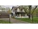 Inviting two-story home with a cozy front porch and an attached garage, nestled in a mature landscape at 543 Schooley Dr, Greenwood, IN 46142