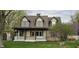 Attractive two-story home featuring a welcoming front porch with a swing, complemented by a well-manicured lawn at 543 Schooley Dr, Greenwood, IN 46142