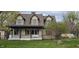 Charming two-story home featuring a covered front porch, lush greenery, and well-maintained landscaping at 543 Schooley Dr, Greenwood, IN 46142