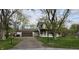 Charming two-story home with attached garage, set back on a lot with mature trees and a long driveway at 543 Schooley Dr, Greenwood, IN 46142