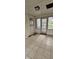 Enclosed porch featuring tiled floors, wood paneling, windows and doors to the outside, and overhead lighting at 543 Schooley Dr, Greenwood, IN 46142