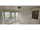 Enclosed porch featuring tiled floors, wood paneling, windows and doors to the outside, and overhead lighting at 543 Schooley Dr, Greenwood, IN 46142