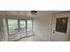 Enclosed porch featuring tiled floors, wood paneling, windows and doors to the outside, and overhead lighting at 543 Schooley Dr, Greenwood, IN 46142