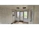 Enclosed porch featuring tiled floors, wood paneling, windows and doors to the outside, and overhead lighting at 543 Schooley Dr, Greenwood, IN 46142