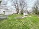 Expansive backyard featuring grassy areas, mature trees, and storage sheds at 5845 South St, Stilesville, IN 46180