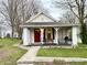 Charming home featuring a brick foundation, red front door, and a cozy front porch at 5845 South St, Stilesville, IN 46180