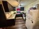 Traditional kitchen with dark cabinets, wood floor, grey countertop and white refrigerator at 5845 South St, Stilesville, IN 46180