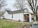 Charming home featuring a brick foundation, red front door, and a cozy front porch at 5845 South St, Stilesville, IN 46180