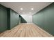 Finished basement with new floors and green walls offering ample space and a contemporary feel at 6107 Rural Dr, Indianapolis, IN 46227