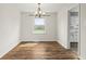 Charming dining room with chandelier, window, and hardwood floors at 6107 Rural Dr, Indianapolis, IN 46227