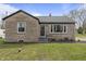 Charming single story home with stone facade and a well-maintained front yard with mature trees at 6107 Rural Dr, Indianapolis, IN 46227