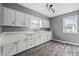 Bright kitchen with white cabinets, light countertops, and modern backsplash at 6107 Rural Dr, Indianapolis, IN 46227