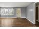 Bright living room with hardwood floors, large window, and neutral paint at 6107 Rural Dr, Indianapolis, IN 46227