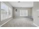 Sunlit bedroom with neutral walls, plush carpeting, and bright windows at 621 Fireside Dr, Greenwood, IN 46143