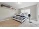 A bright and cozy bedroom featuring a plush carpet, light walls, and a simple, comfortable bed setup at 621 Fireside Dr, Greenwood, IN 46143
