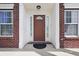 Close-up of the front door, flanked by windows and adorned with elegant molding at 621 Fireside Dr, Greenwood, IN 46143