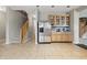 Kitchen with staircase access, stainless steel appliances, and wood cabinetry at 621 Fireside Dr, Greenwood, IN 46143