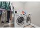 Bright laundry room featuring modern LG washer and dryer set and open space for sorting and folding at 621 Fireside Dr, Greenwood, IN 46143
