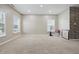 Spacious living room with neutral carpet and a decorative stone accent wall at 621 Fireside Dr, Greenwood, IN 46143