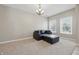 Comfortable living room features carpet, neutral walls, a modern ceiling fan, and a sectional sofa at 621 Fireside Dr, Greenwood, IN 46143
